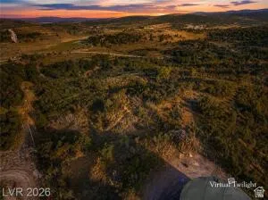 Expansive undeveloped land with diverse vegetation and distant mountain ranges