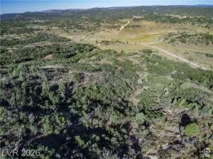 Expansive undeveloped lot with natural terrain and scattered trees