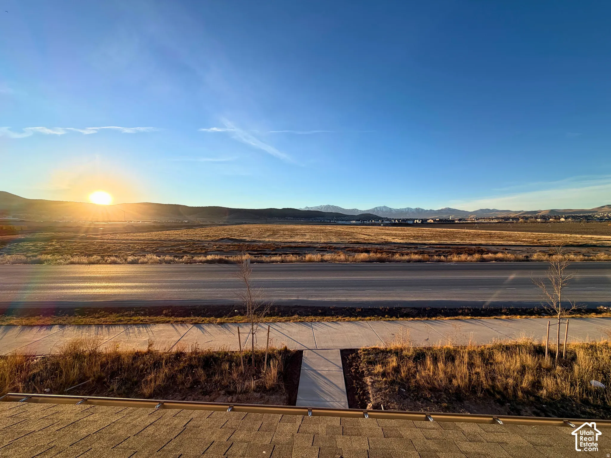 Expansive rural surroundings with distant mountains and a clear sky