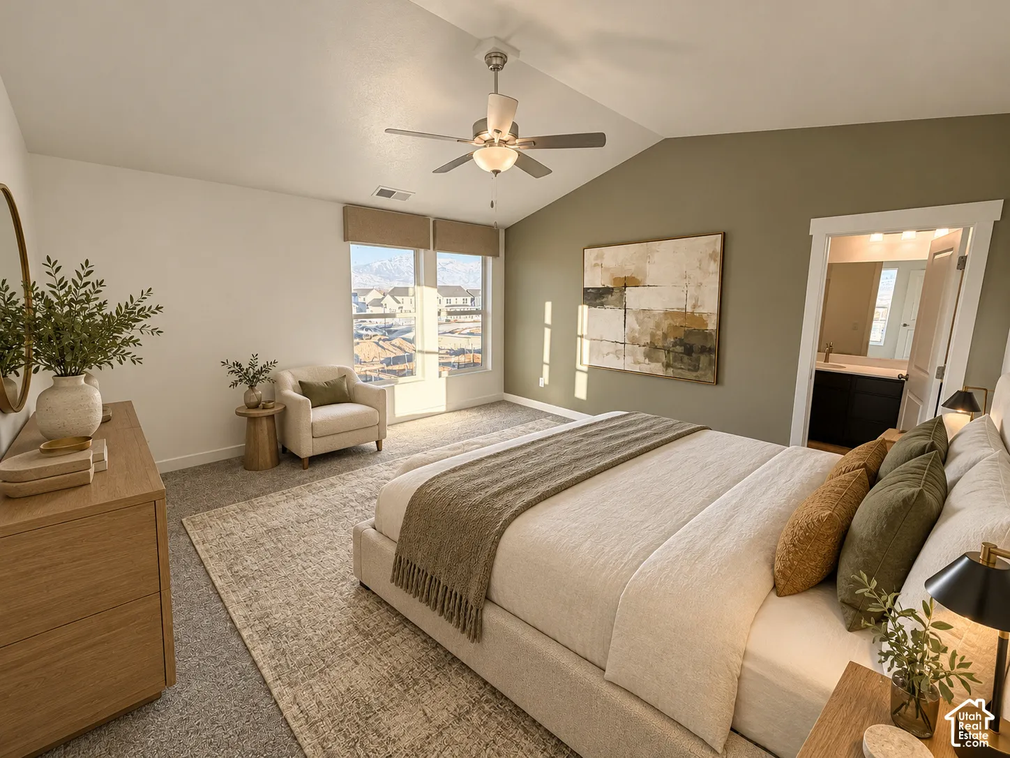 Vaulted ceilings, carpeted flooring, a ceiling fan with integrated lighting, and large windows with mountain scenery