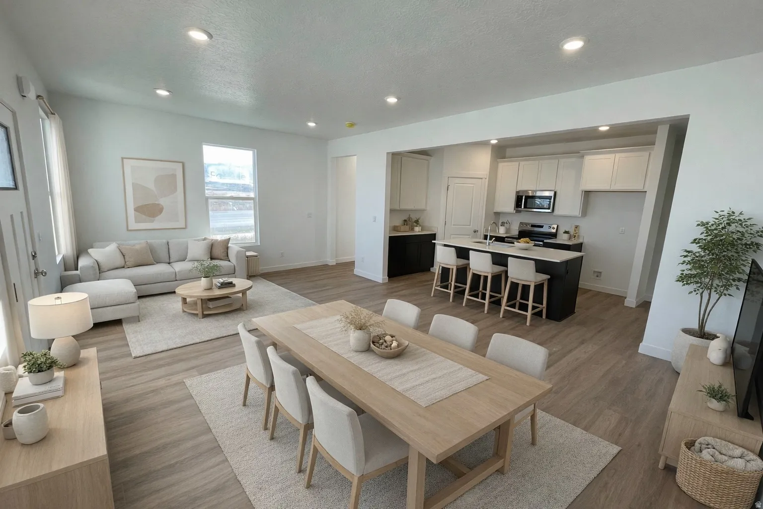 Open-concept living space featuring wood-finish flooring, recessed lighting, and large windows