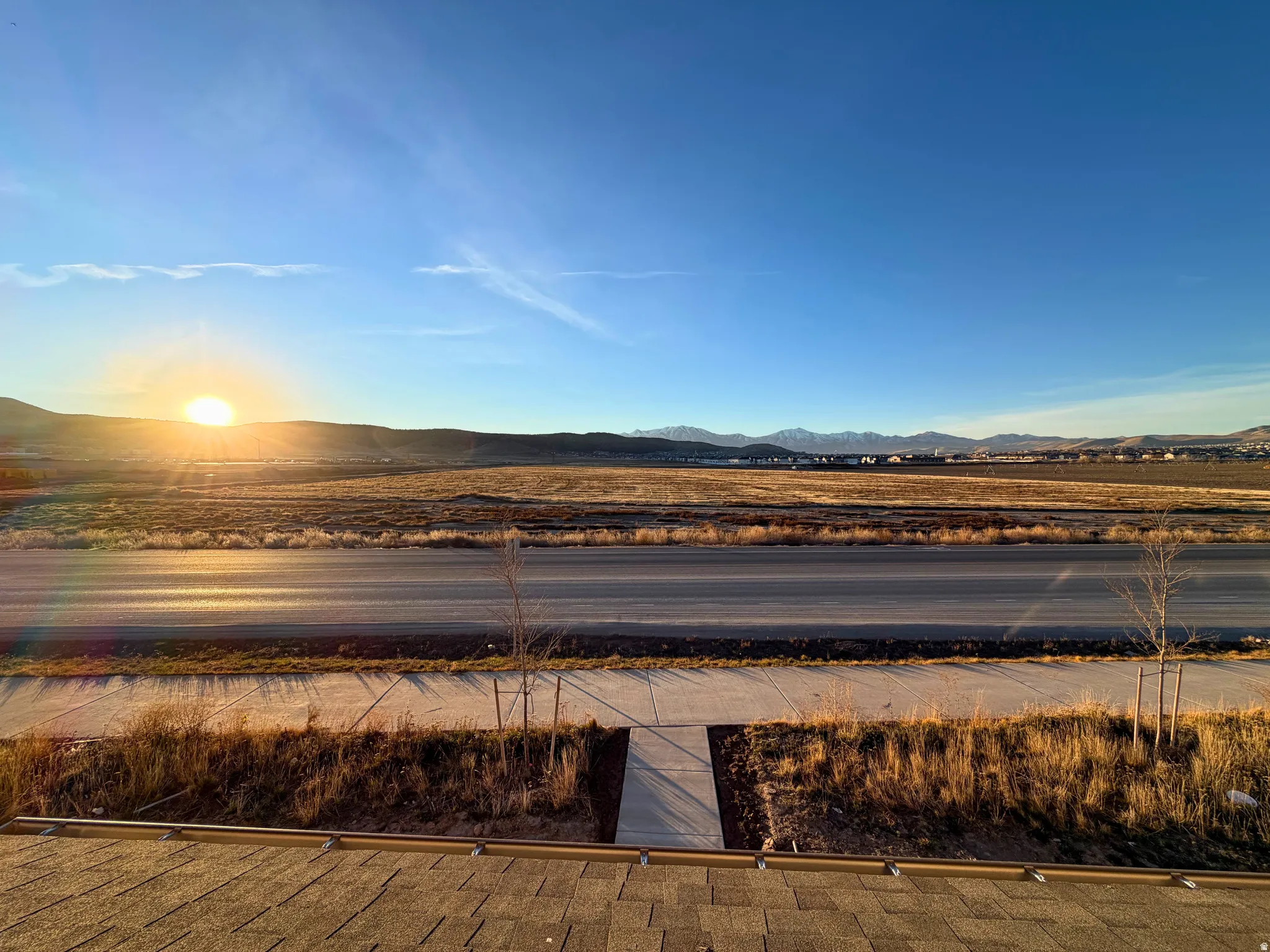 Expansive rural surroundings with distant mountains and a clear sky