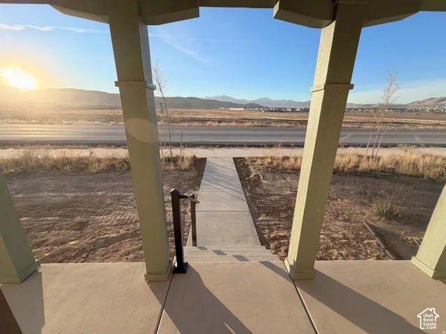 Covered outdoor porch with concrete flooring and angled support columns