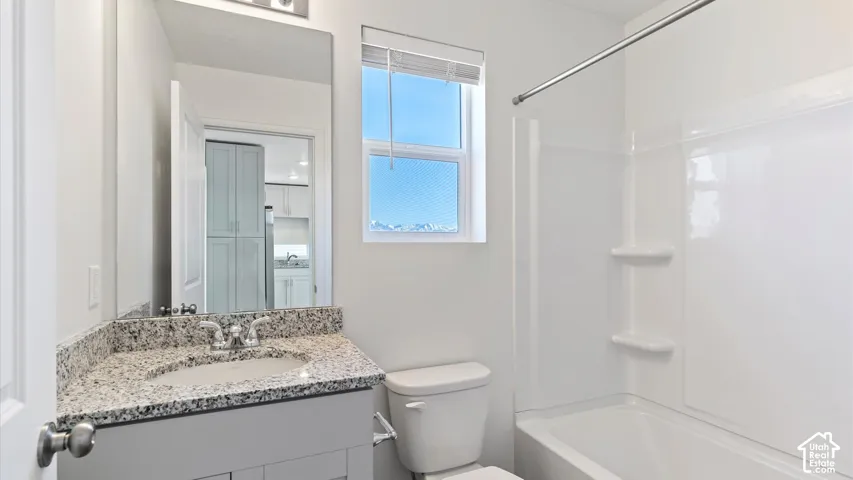 White shaker vanity with granite countertop and undermount sink