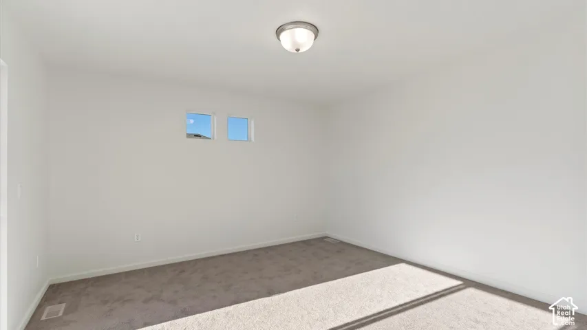 Recessed lighting, light gray carpeting, and white painted walls