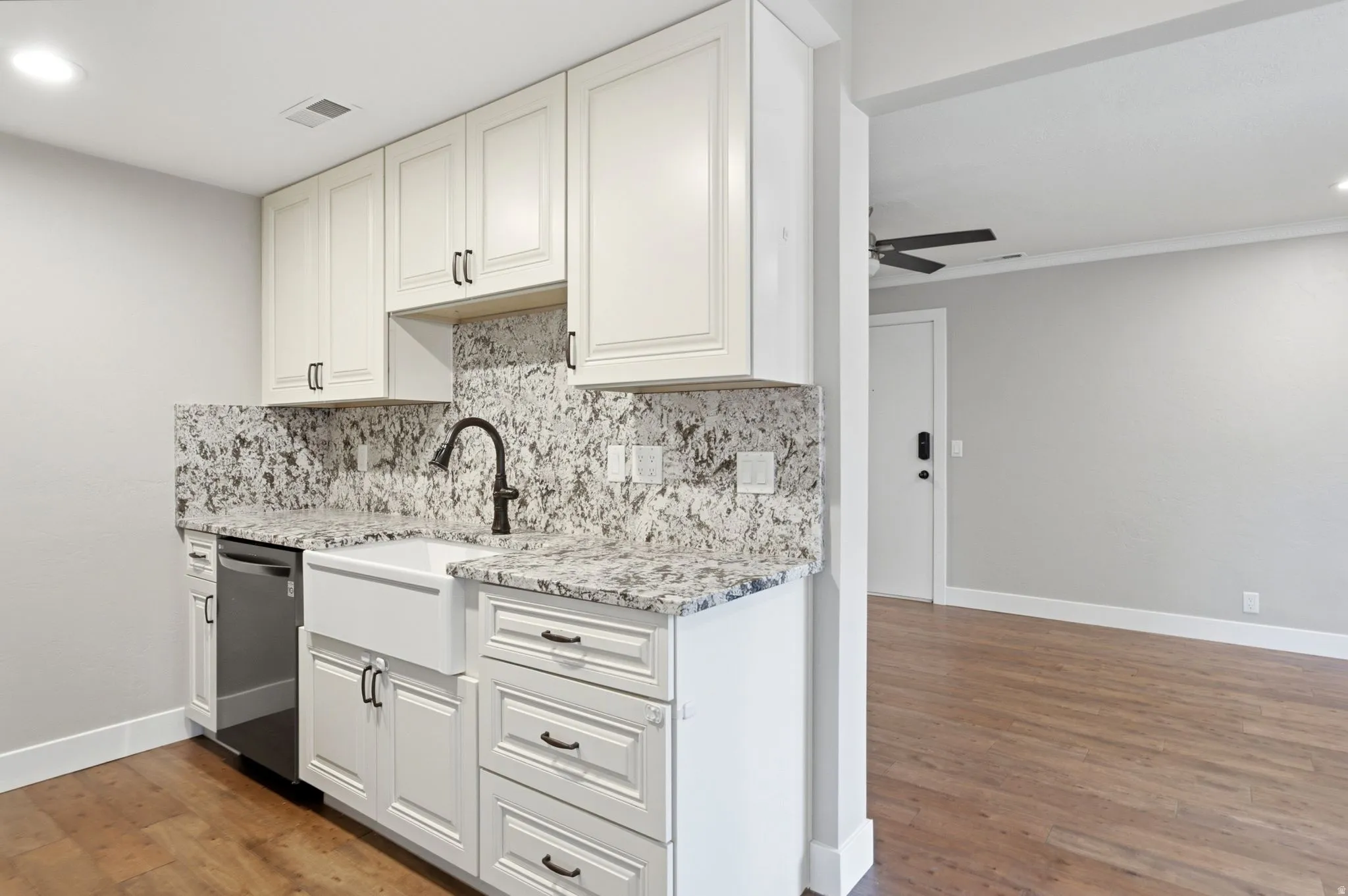White shaker cabinetry with dark hardware