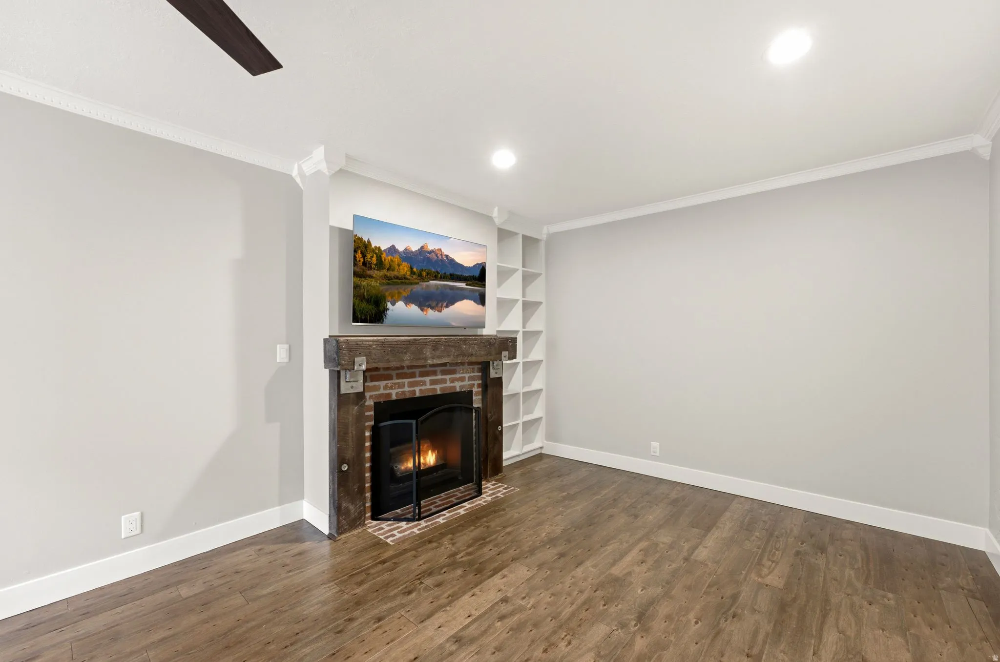 Fireplace with brick surround and a substantial wood-finish mantel