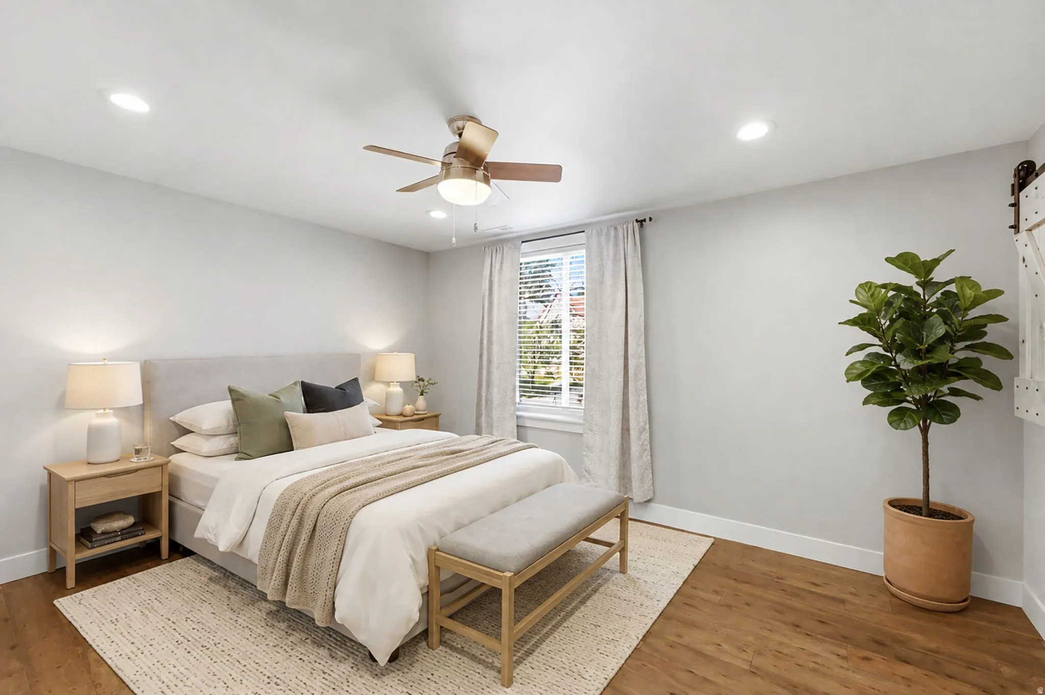 Recessed lighting, wood-finish flooring, ceiling fan with light fixture, window with blinds, and a barn door accent