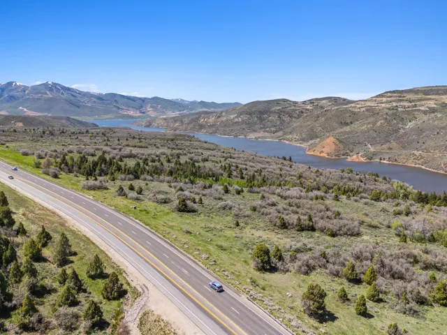 Expansive natural landscape featuring a prominent lake and distant mountains