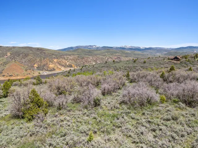 Expansive natural landscape featuring varied terrain and distant snow-capped mountains