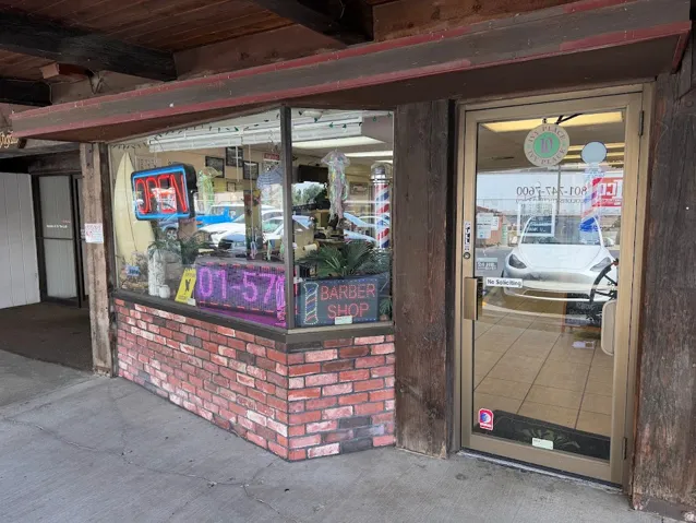 Storefront entry with an aluminum-framed glass door, large display windows, and a brick-finish facade