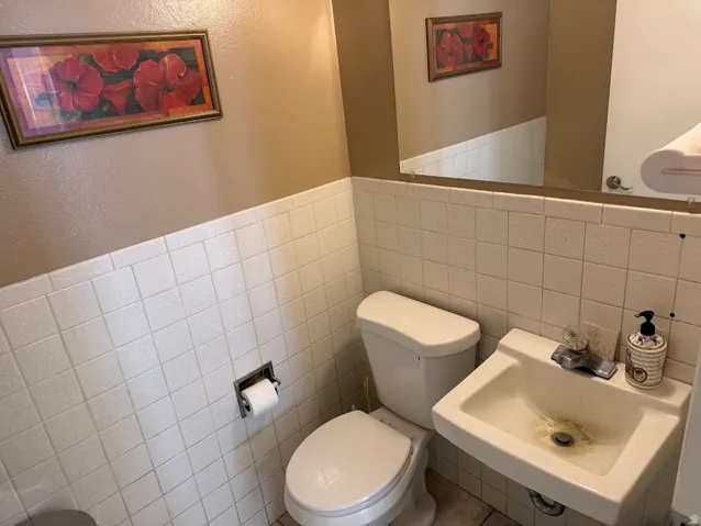 White ceramic wall-mounted sink with chrome faucet