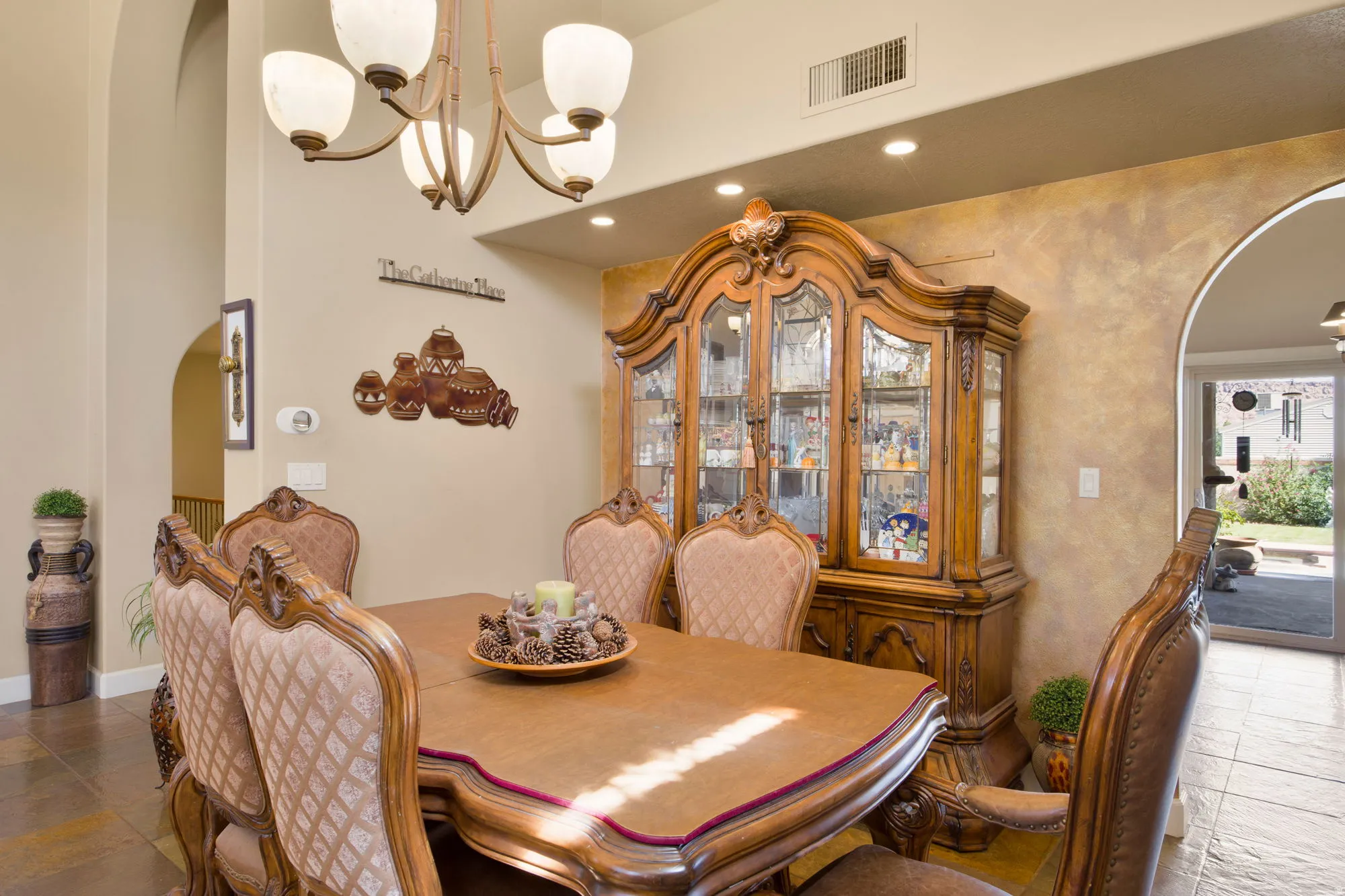 Recessed ceiling lighting, arched entryway, and sconce lighting
