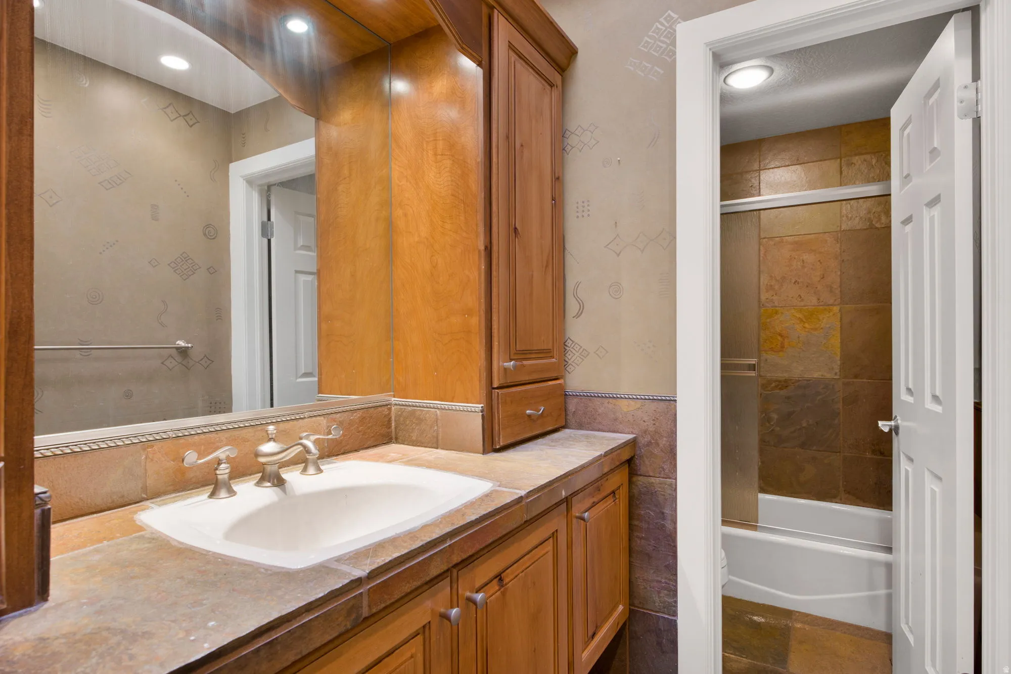 Wood-finish cabinetry with an integrated sink and brushed nickel faucet