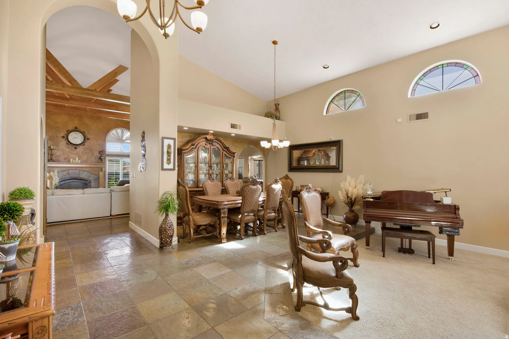 Archways define the entry, complemented by high vaulted ceilings and recessed lighting