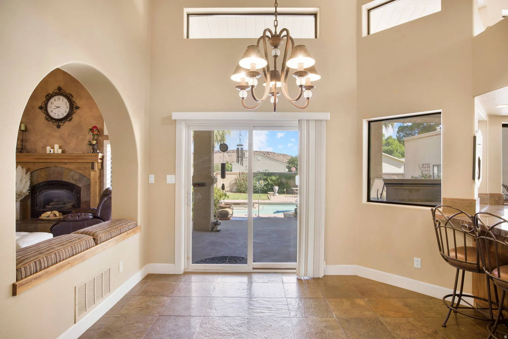 Soaring vaulted ceilings with transom windows flood this open-concept living space with natural light