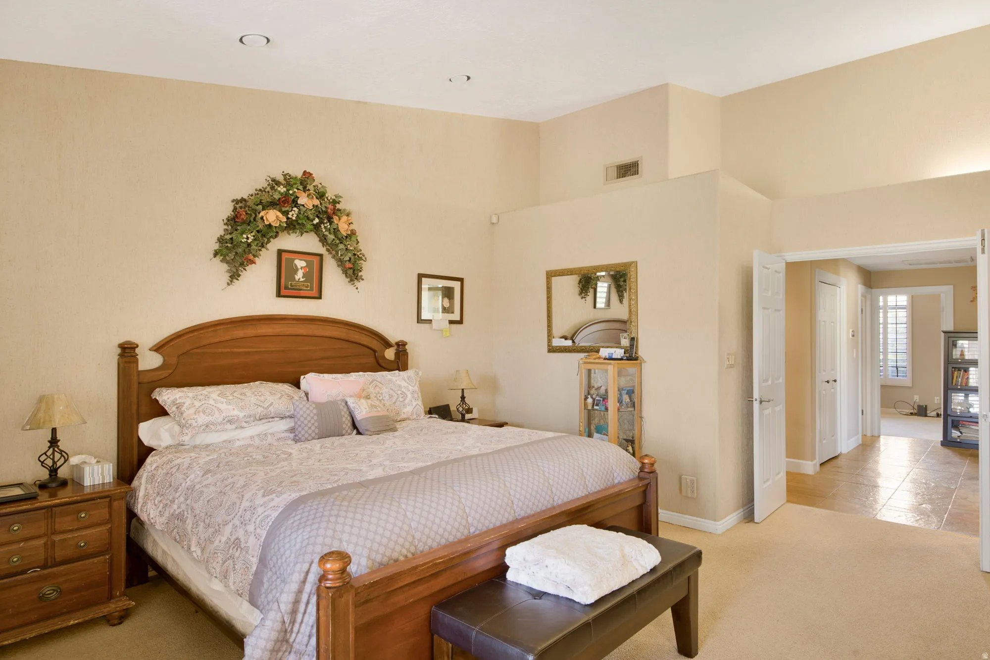 Vaulted ceiling, recessed lighting, double-door entry, carpeted flooring, and tiled flooring