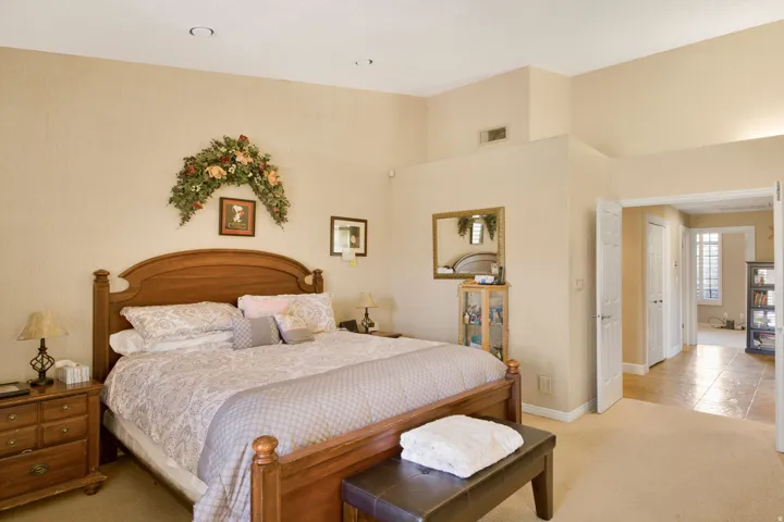 Vaulted ceiling, recessed lighting, double-door entry, carpeted flooring, and tiled flooring