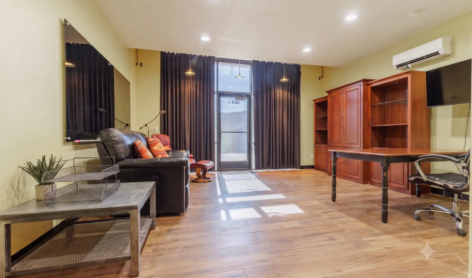Suite 7 office — glass storefront entry, wood-look tile
