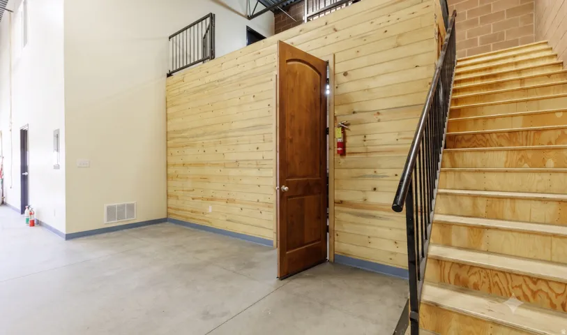 Stairs to upper office; storage beneath mezzanine