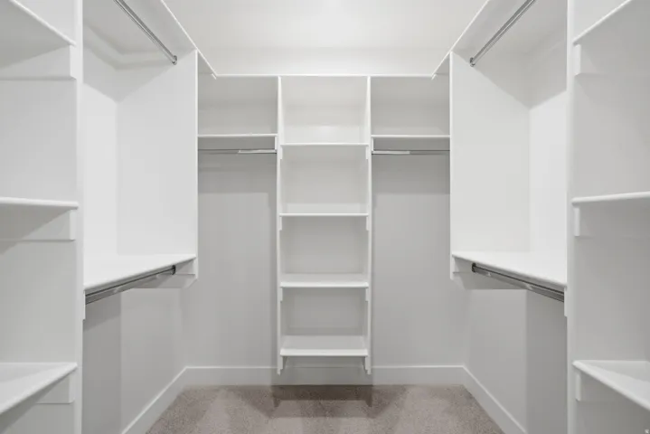 Custom closet system featuring multiple shelves and hanging rods