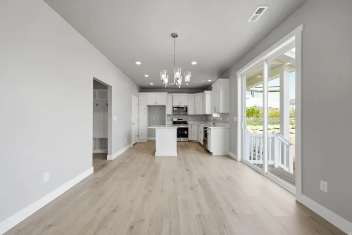 Contemporary kitchen with white cabinetry, stainless steel appliances, and an island