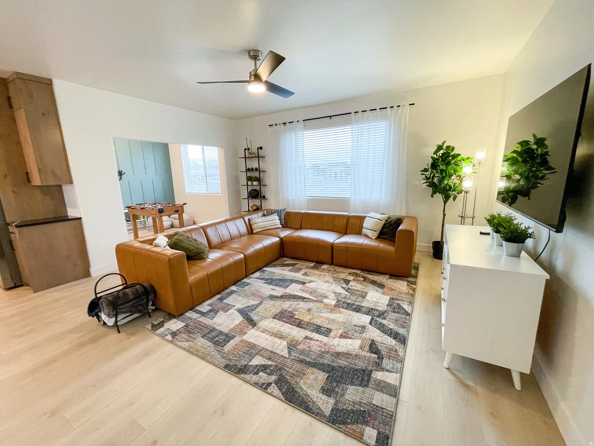 Recessed lighting, wood-finish flooring, ceiling fan, and window with blinds