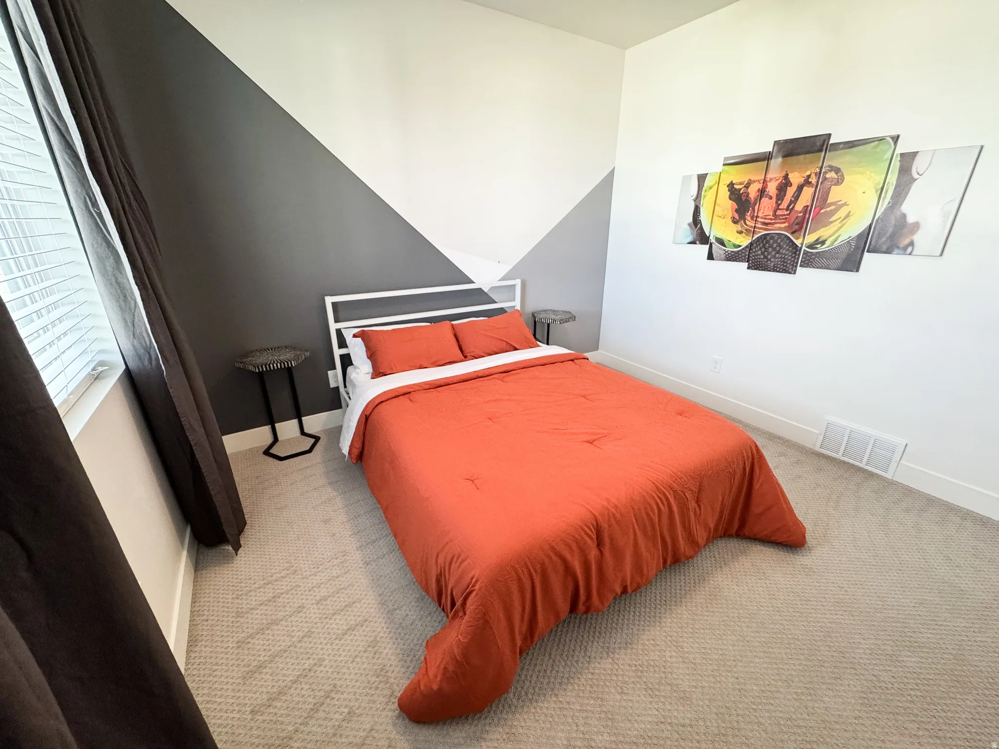 Textured carpeting, two-toned accent wall, white window blinds, and white trim