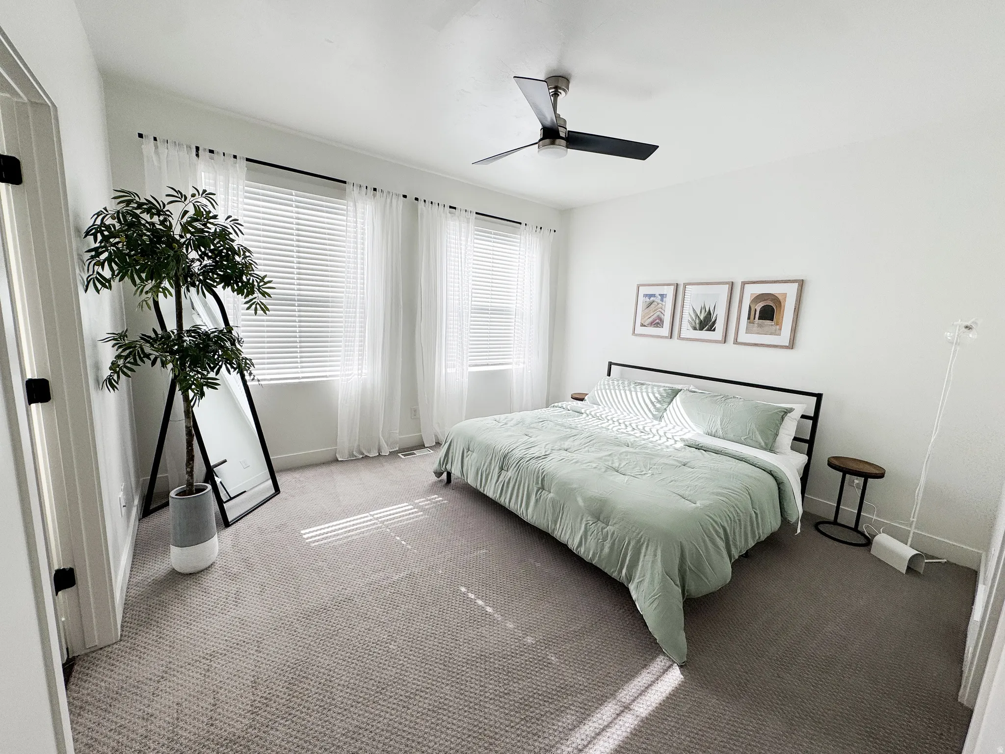 Recessed lighting, ceiling fan with integrated light, multiple windows with blinds, and neutral wall tones