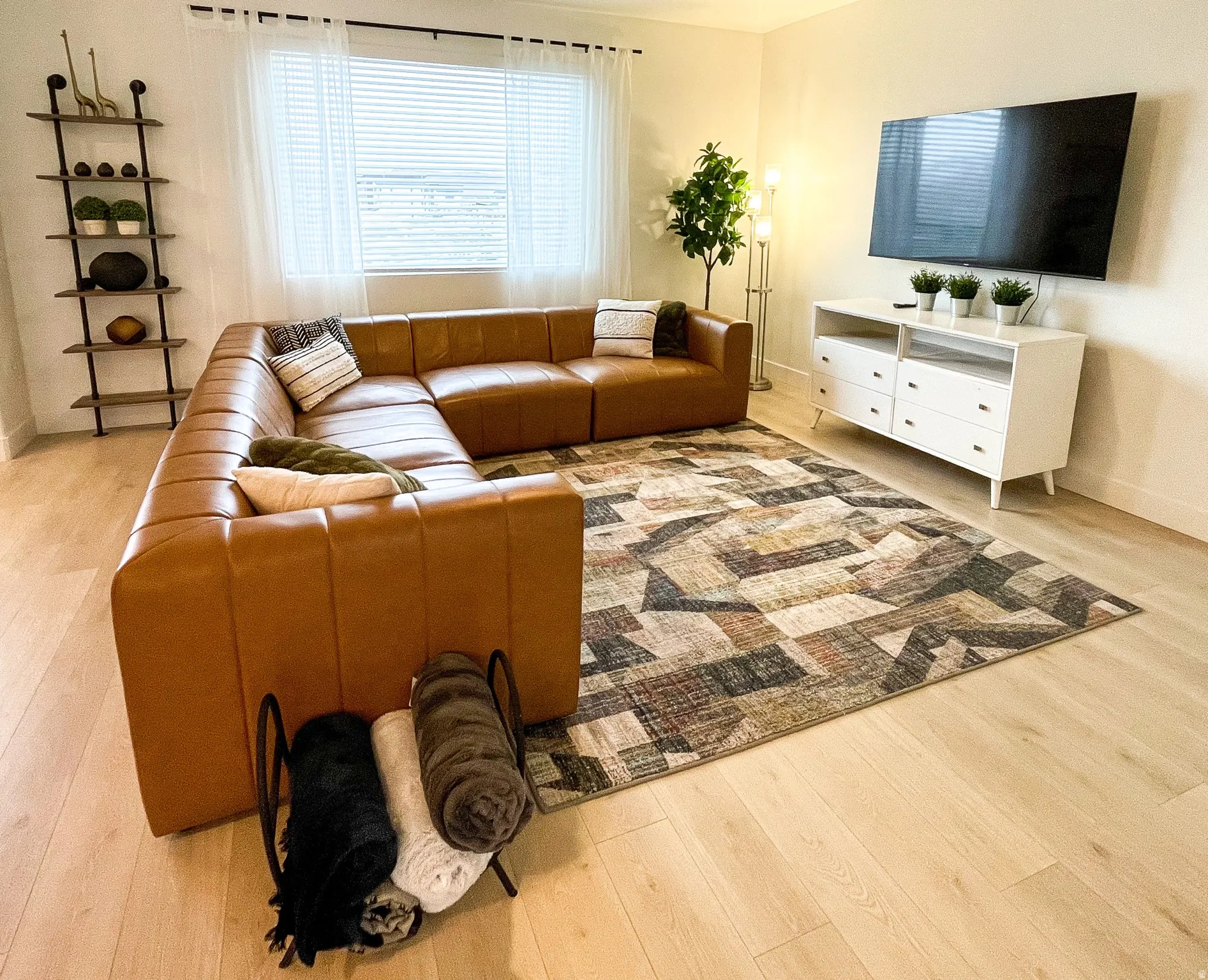 Recessed lighting illuminates wood-finish flooring