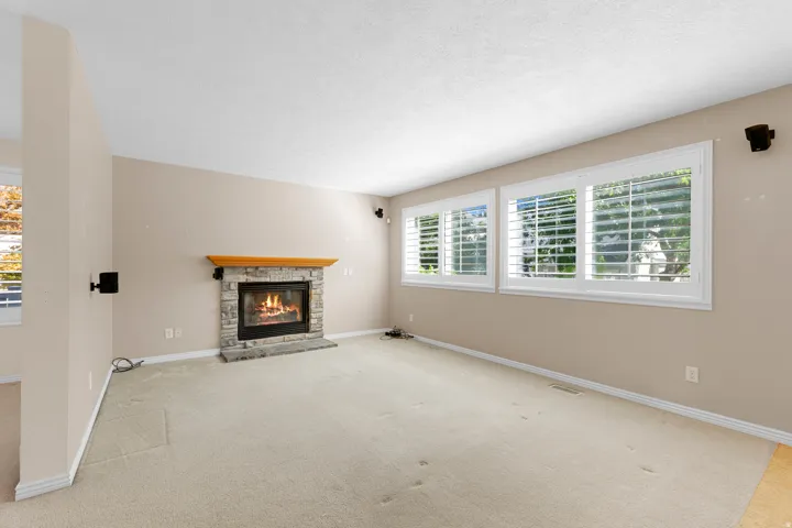 Stone-clad fireplace with a wood mantel