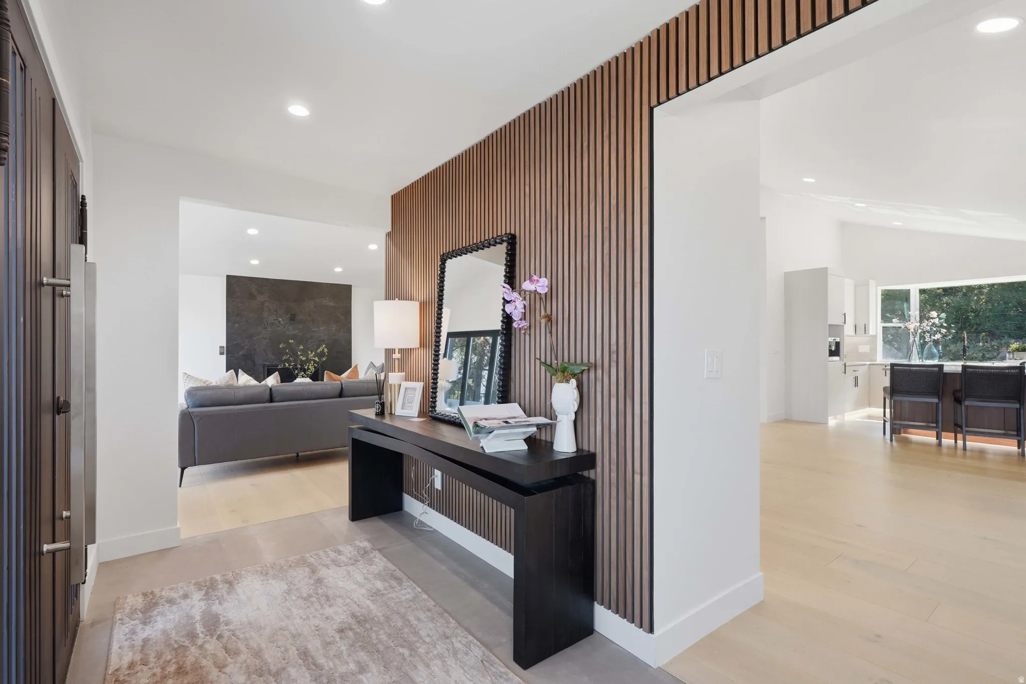 Entryway featuring a wood-slat accent wall, recessed lighting, and light wood-finish flooring