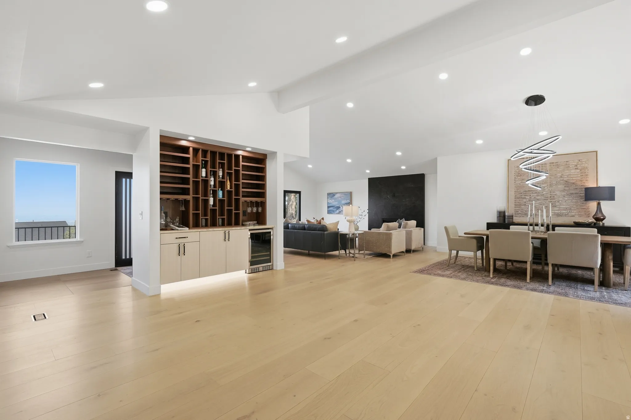 Expansive light wood-finish flooring throughout