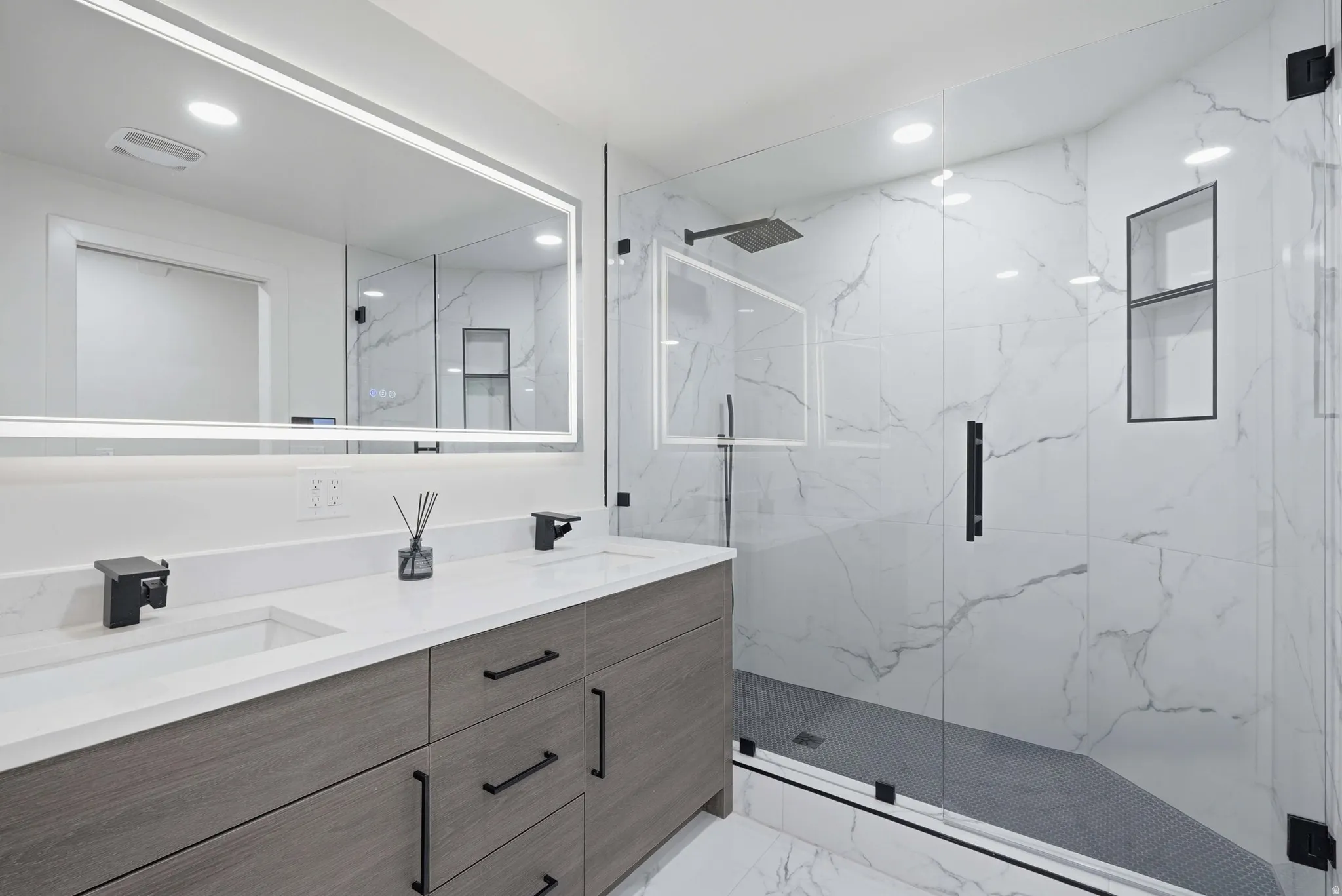 Dual vanity with integrated sinks, quartz countertop, and wood-finish cabinetry