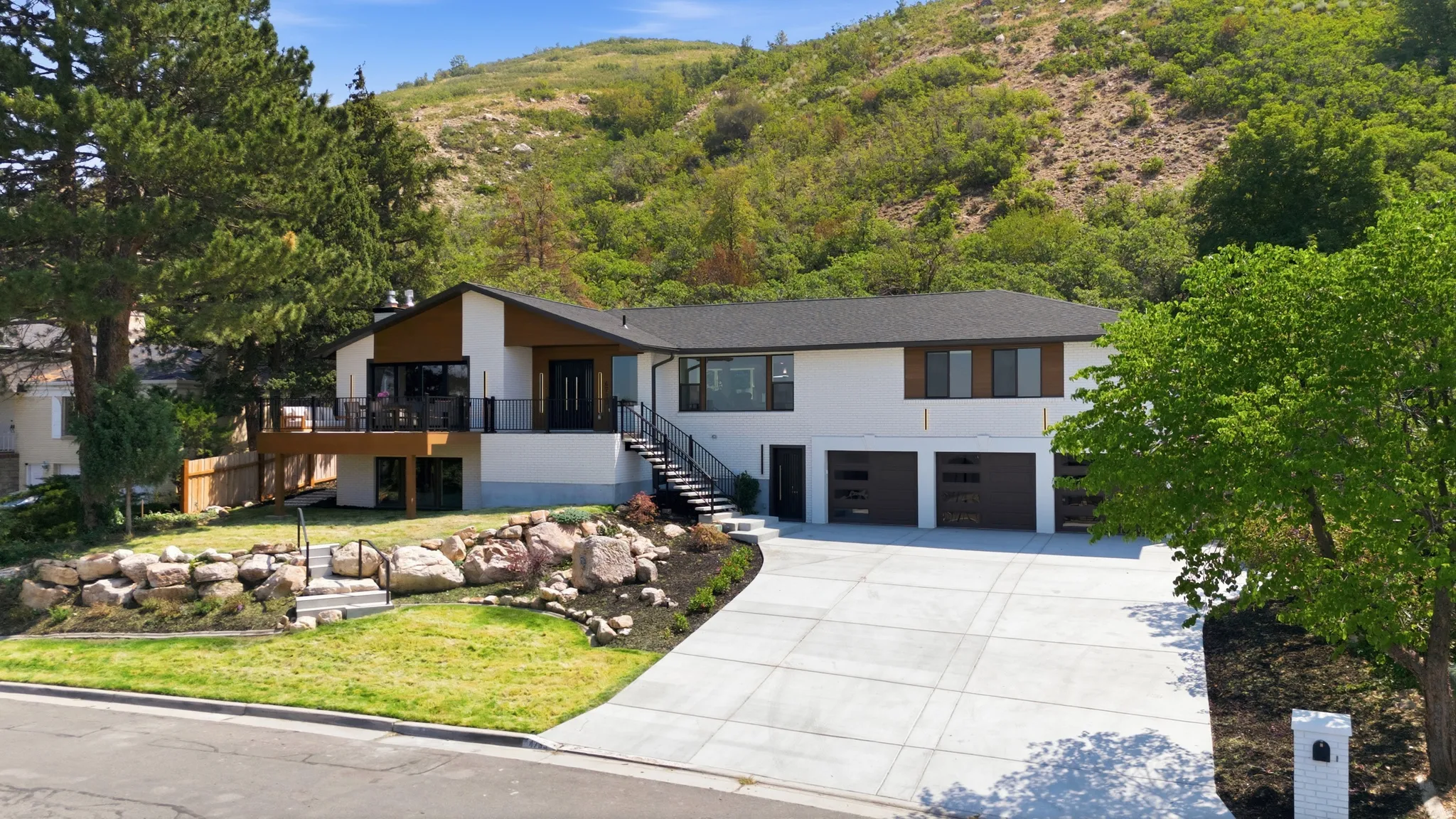 Modern exterior with white siding and wood-finish accents