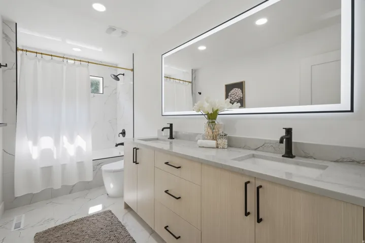 Dual vanity with integrated sinks and matte black fixtures