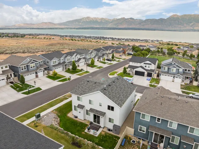 Newly developed neighborhood with paved streets and sidewalks, featuring multiple two-story residences