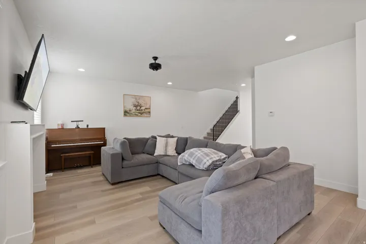 Wood-finish flooring throughout, recessed lighting, and a white wall finish