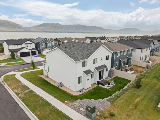 Modern two-story residence featuring a clean architectural design with mixed exterior finishes including white siding and dark accents