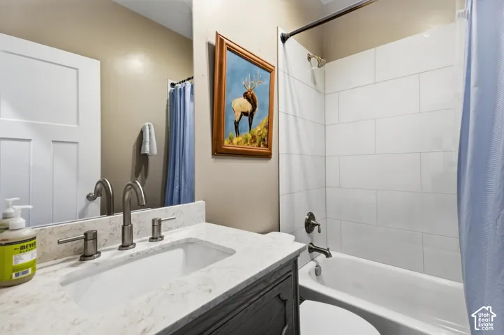 Vanity with an integrated sink, brushed nickel fixtures, and a light-toned countertop