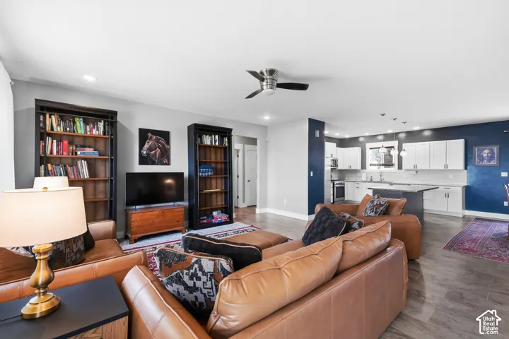 Open-concept living space featuring wood-finish flooring, recessed lighting, and a ceiling fan
