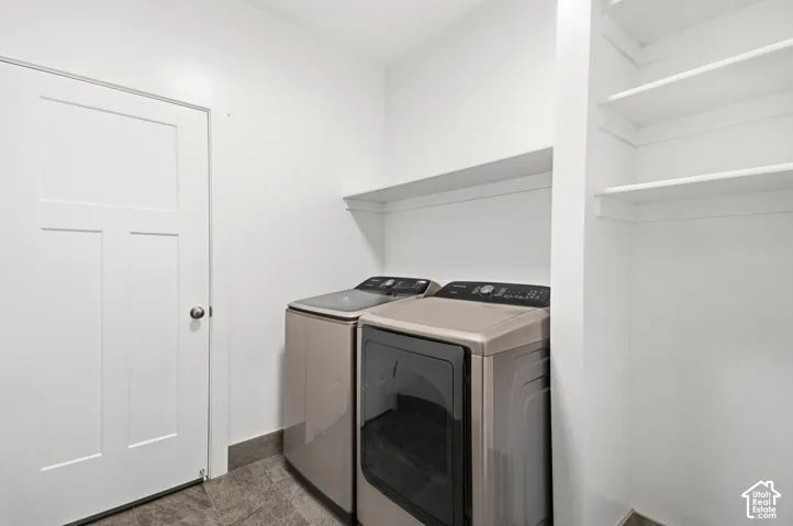 Laundry area featuring a three-panel door, built-in shelving, and a wall-mounted shelf