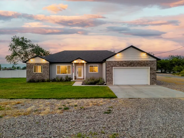 Contemporary ranch-style residence featuring stone and siding exterior accents