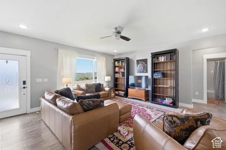 Spacious living area featuring wood-finish flooring, recessed lighting, and a ceiling fan