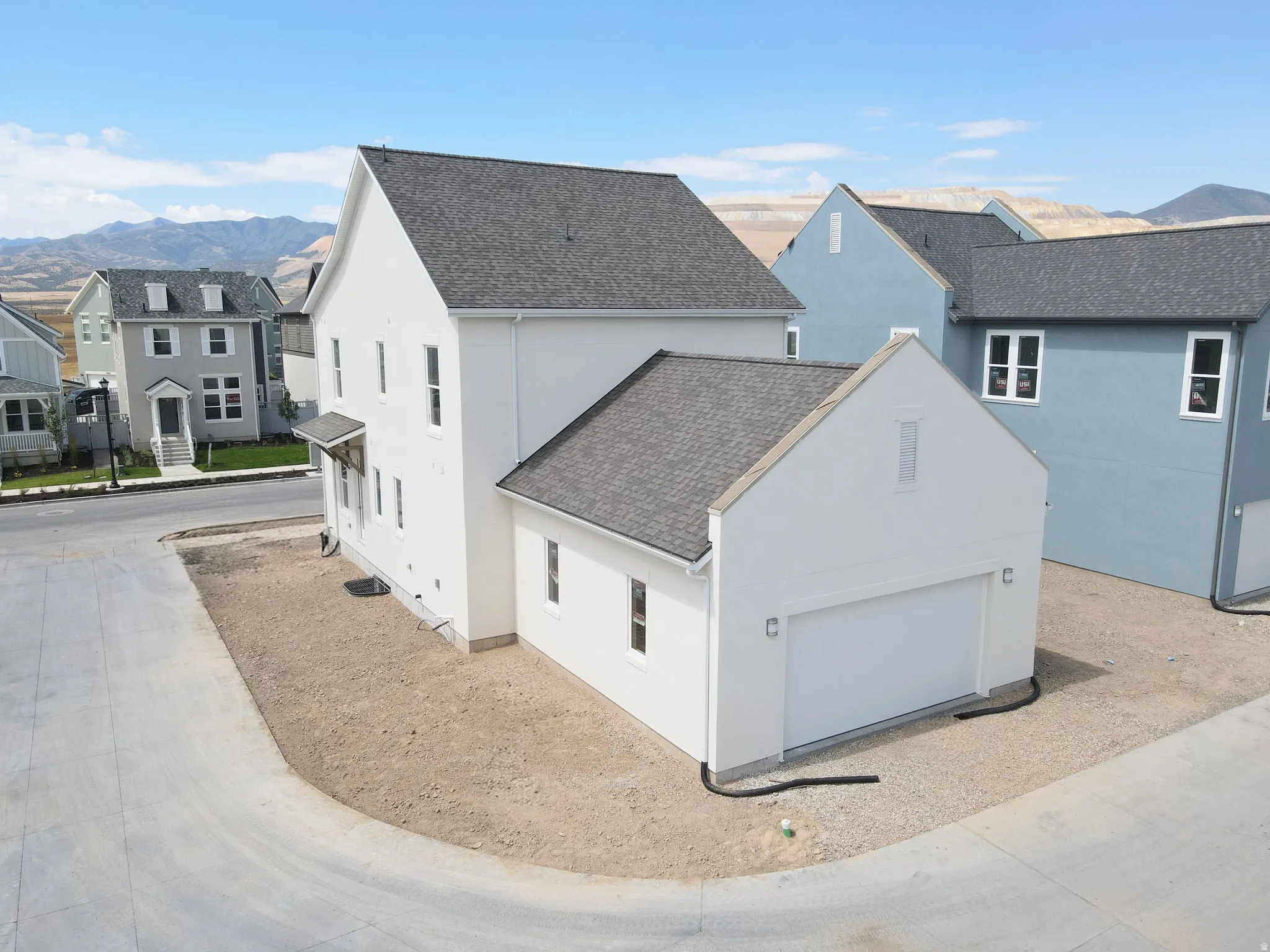 Modern white stucco exterior with an attached two-car garage