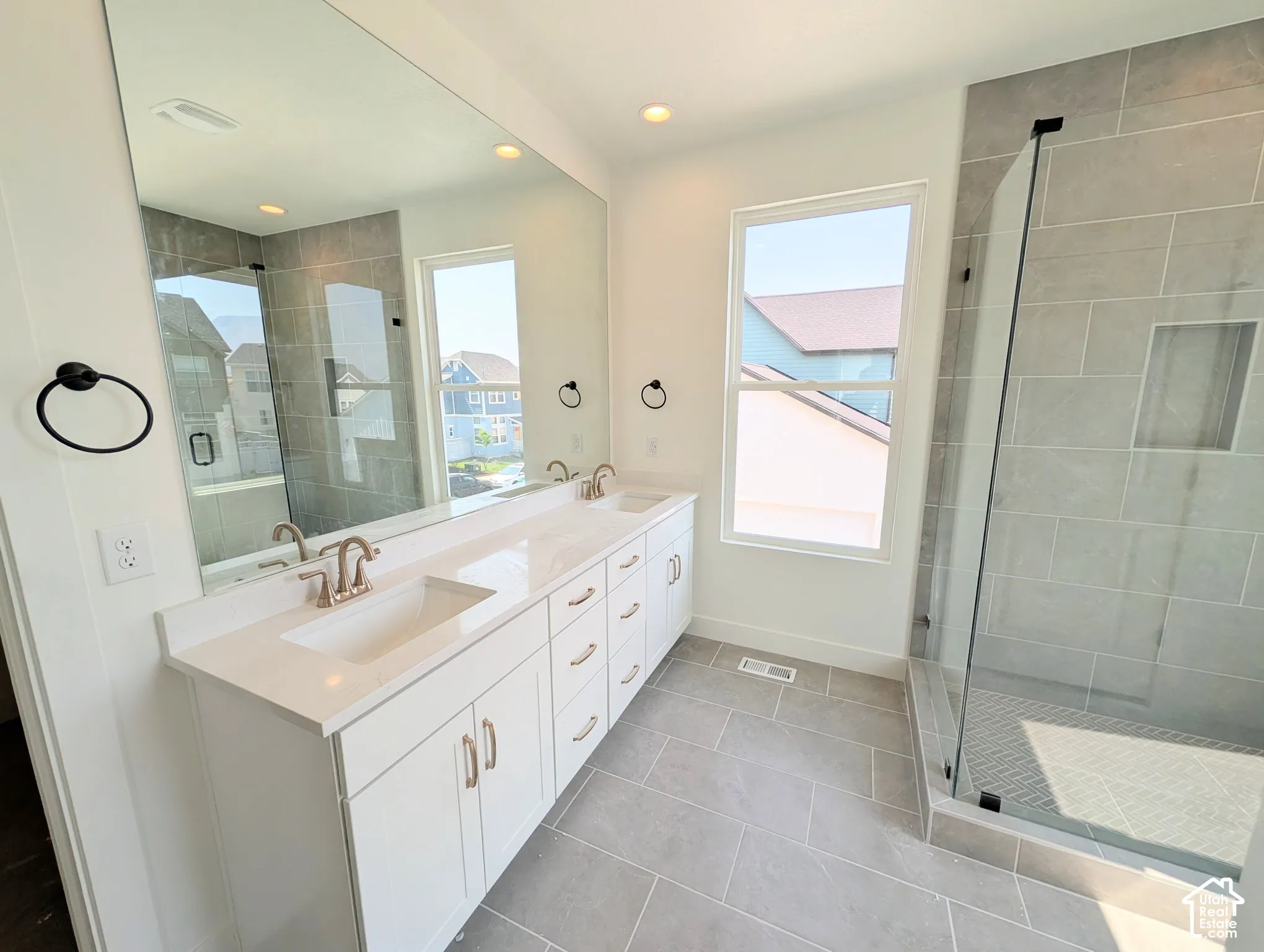 Dual vanity with undermount sinks, quartz countertop, and brushed nickel fixtures
