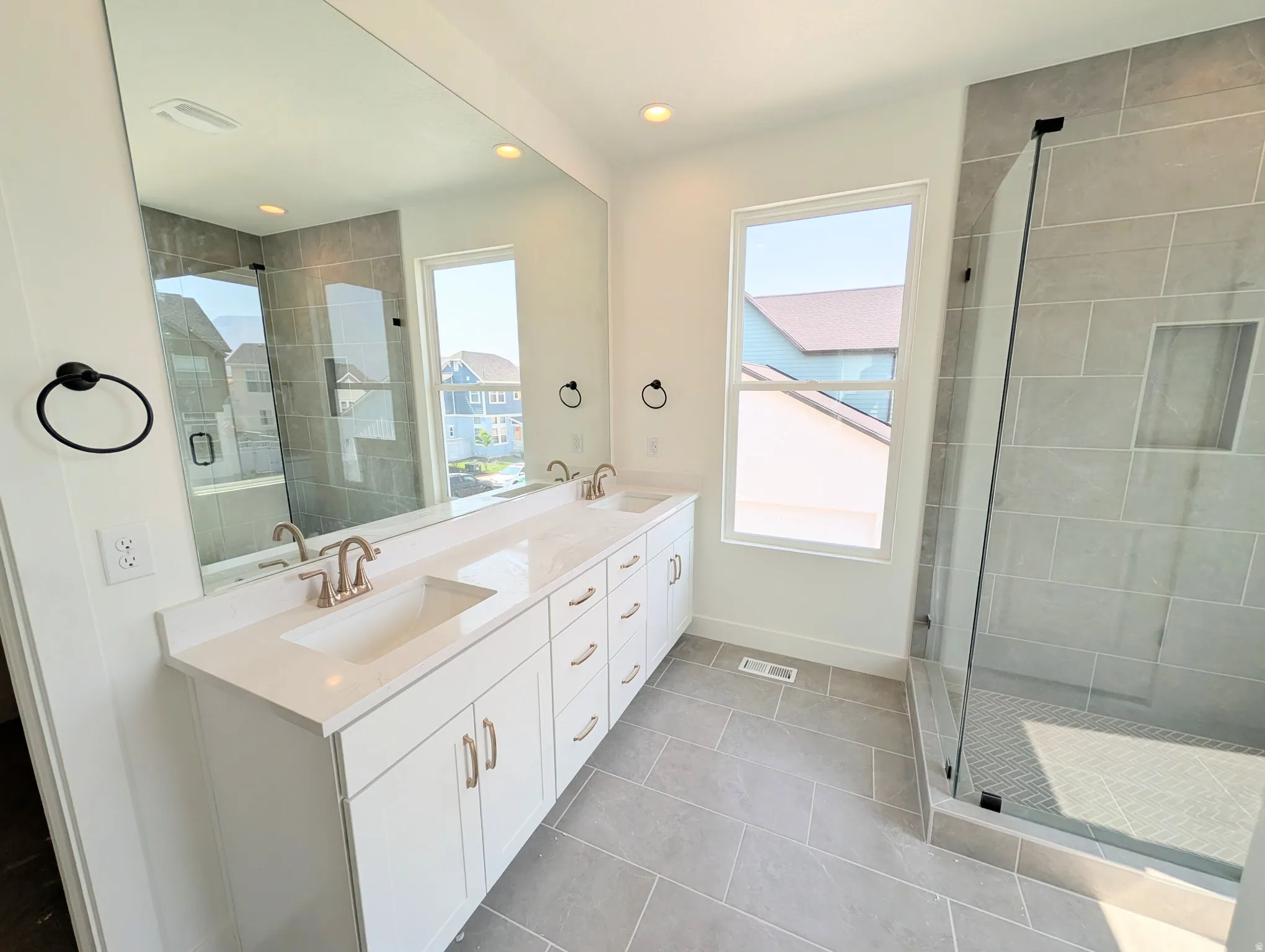 Dual vanity with undermount sinks, quartz countertop, and brushed nickel fixtures