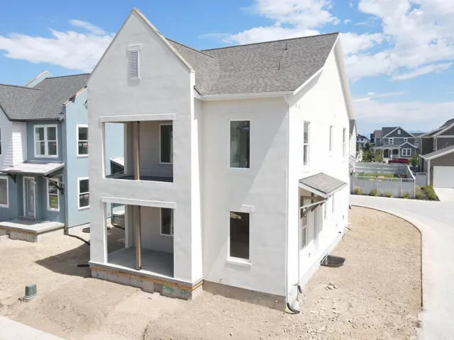 Two-story white stucco exterior featuring a prominent gabled roofline