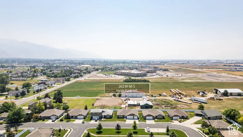 Aerial view showcasing this newer residential development with manicured landscaping, wide tree-lined streets, and spacious home sites