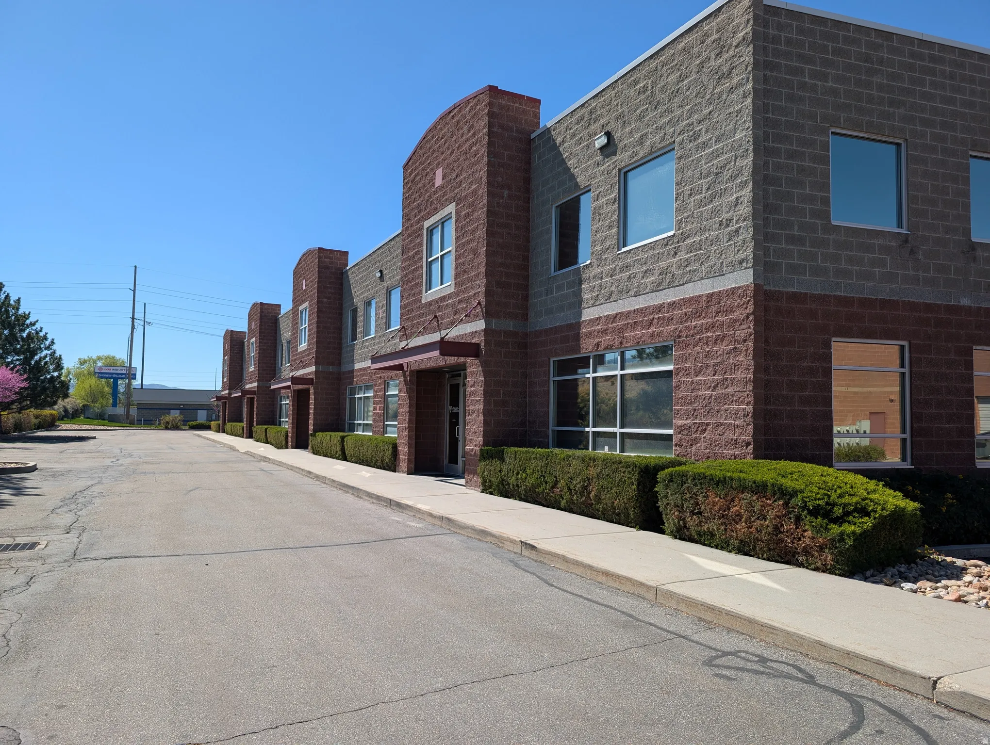 Multi-story building featuring a brick facade with a stone-finish upper level